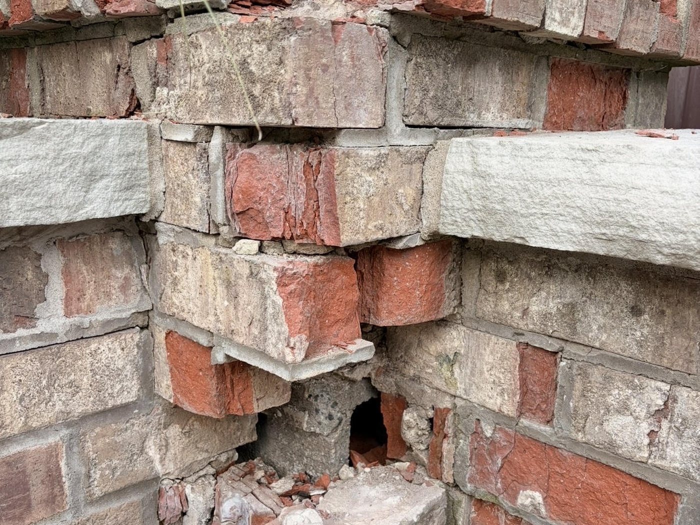 Before: a crumbling brick pillar corner with loose, broken bricks and an open hole near the base